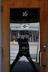 怪しい日本語の扉を怪しい体勢で撮影する怪しい日本人