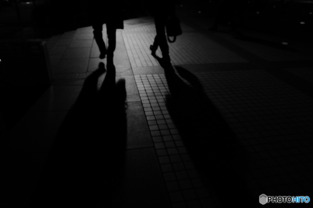 Two men walking in midnight