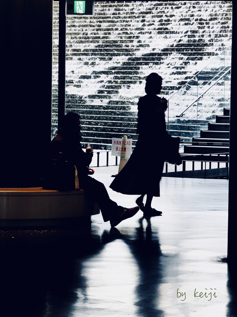 A woman facing the waves