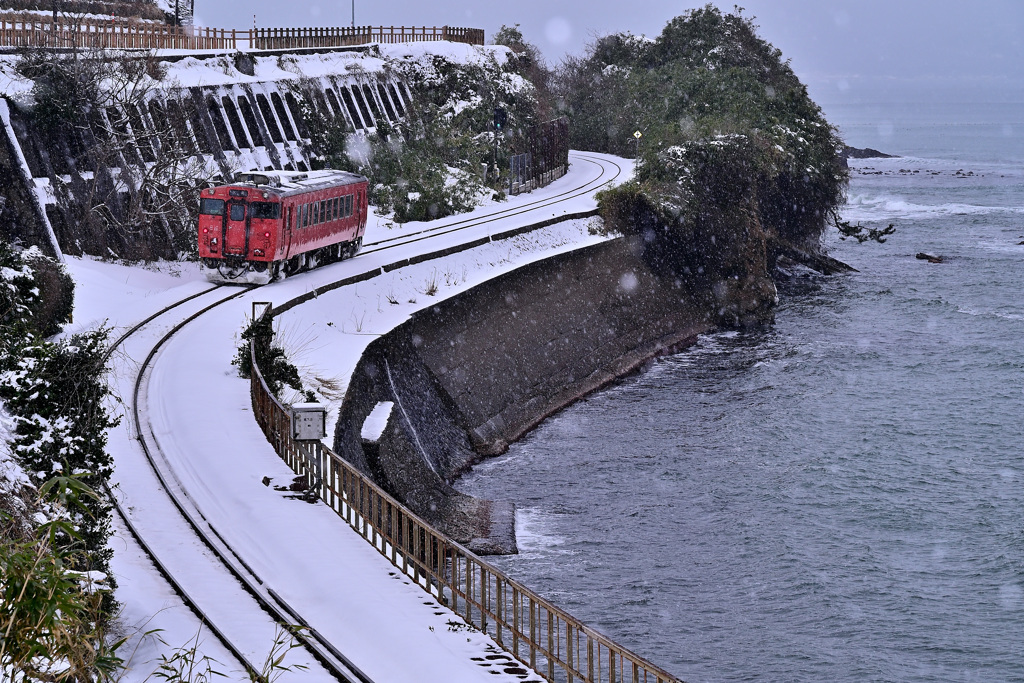 雪降る富山湾氷見線