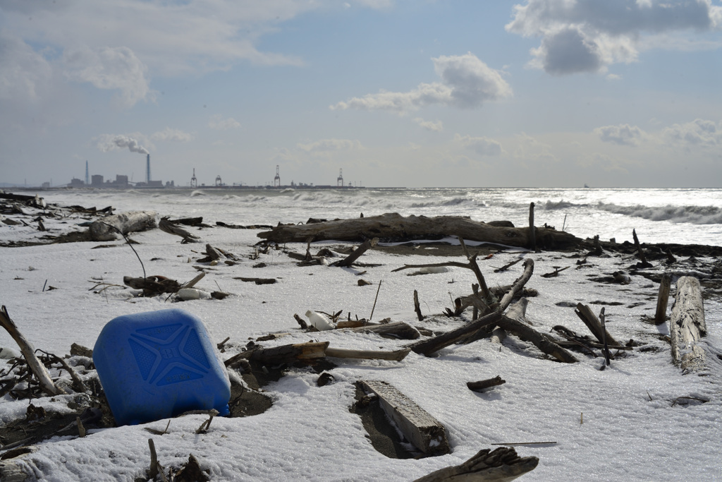 Blue containers washed up on the beach.