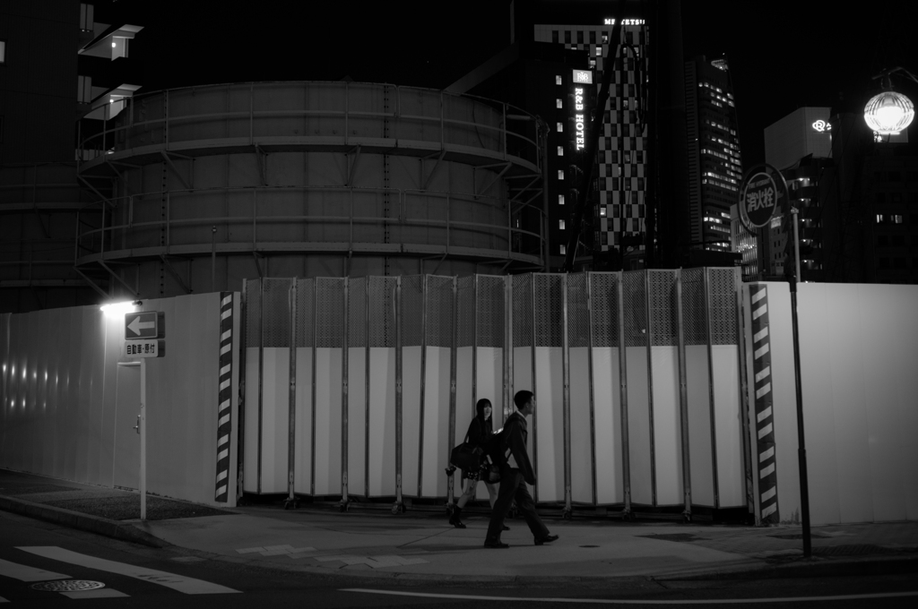 In front of a large tank.