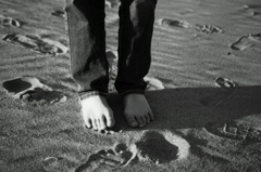 on a sand beach barefoot