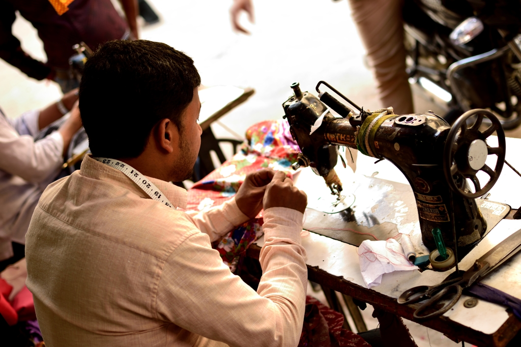 Man using a sewing machine in Green Park