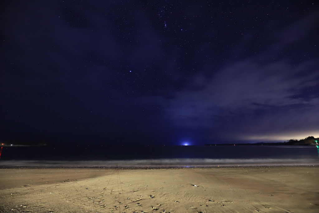 砂浜と海と漁火と星空