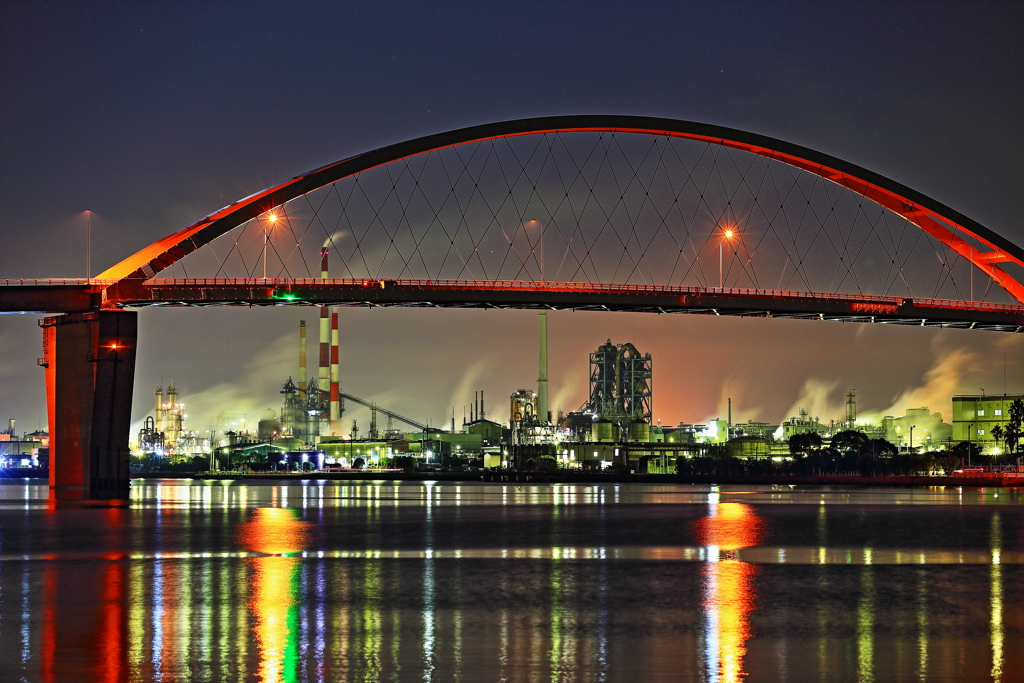 illuminated factories over the bridge