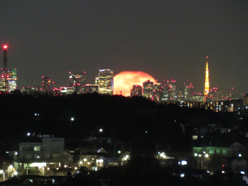 超高層ビルと月の出