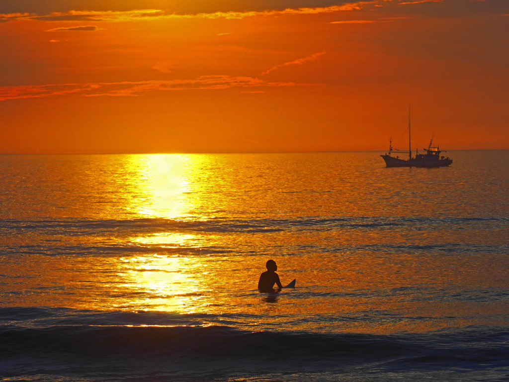 波待ちサーファーと漁船