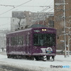 雪の中を走る嵐電