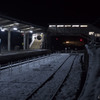雪の駅に近づく灯り