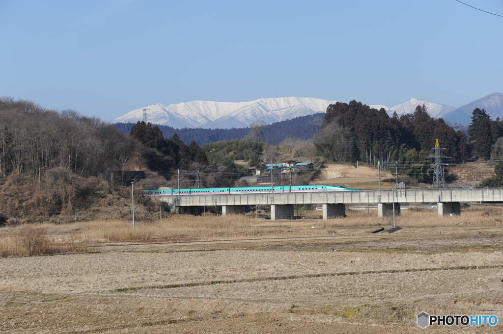 雪の蔵王連峰を背景にE5系