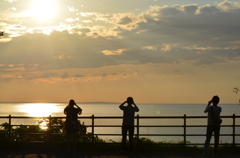 オホーツクの夕日を撮影する人