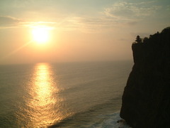 崖の寺院と夕日と海