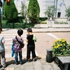 服を肩にかける少年　